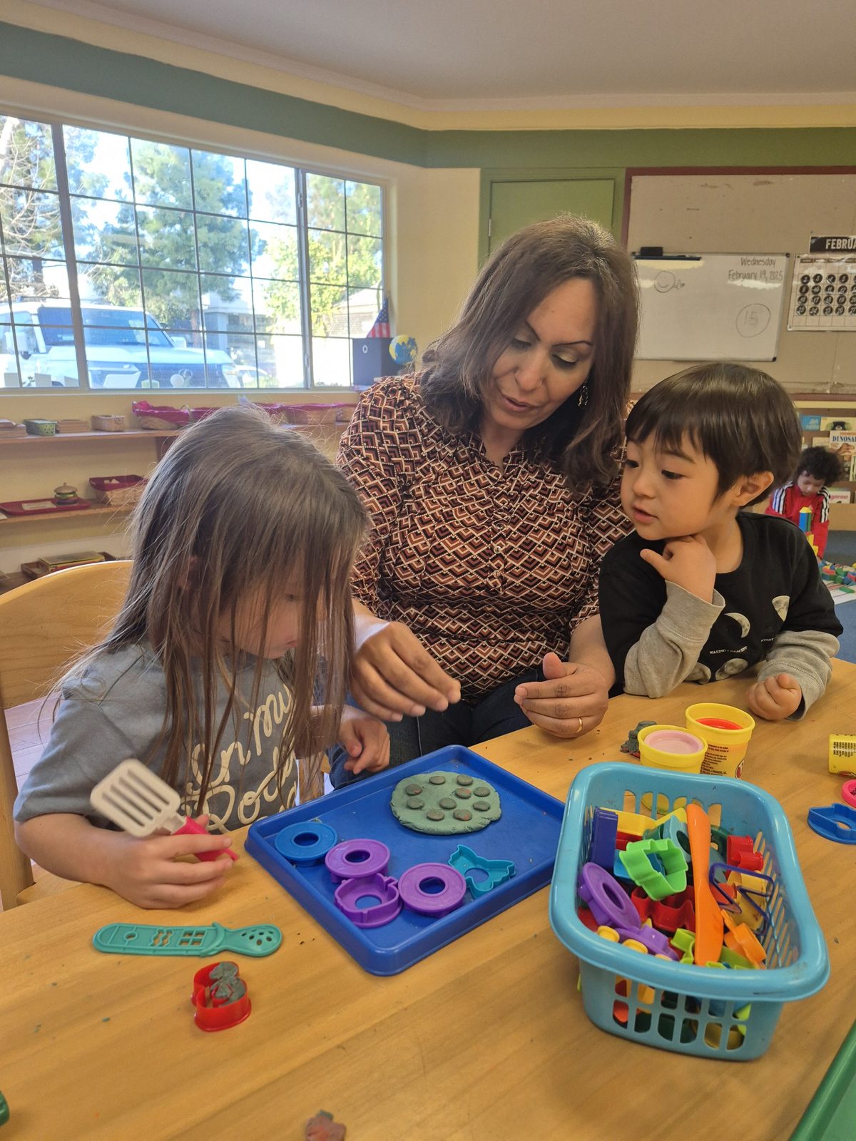 Children sorting colors and shapes with their teacher